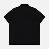 The Abstract Jersey Cuba Shirt by 04651/ A TRIP IN A BAG features a Cuban collar, short sleeves, and a back view against a white background. Made from lightweight cotton for comfort.