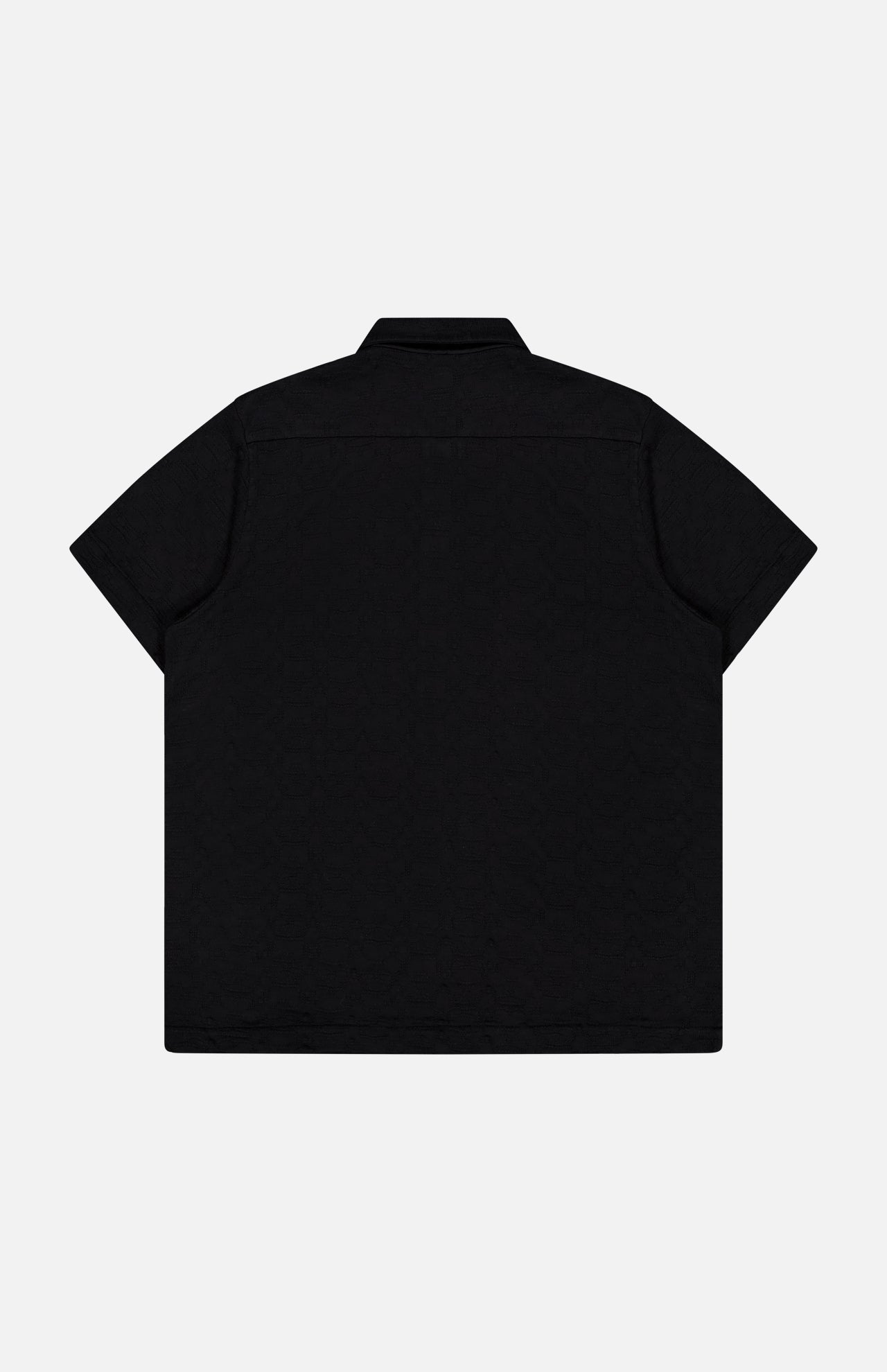 The Abstract Jersey Cuba Shirt by 04651/ A TRIP IN A BAG features a Cuban collar, short sleeves, and a back view against a white background. Made from lightweight cotton for comfort.