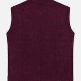 The Boiled Virgin Wool Vest by 04651/ A TRIP IN A BAG is shown from the back in a rich wine tone, featuring a sleeveless design, straight hem, and minimal detailing, set against a plain white background.