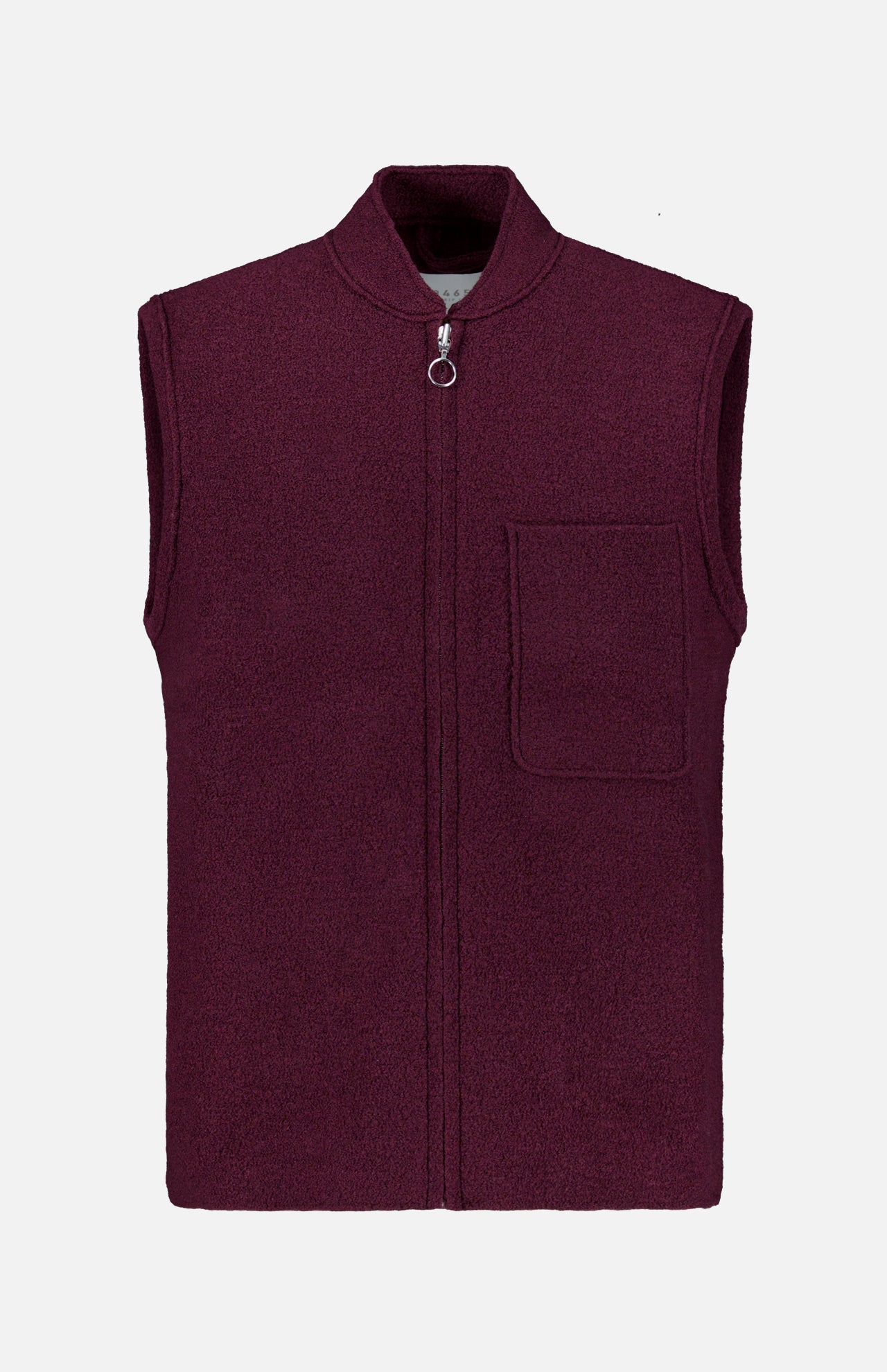 A sleeveless Boiled Virgin Wool Vest by 04651/ A TRIP IN A BAG, in a wine tone, crafted from soft fleece, featuring a front zipper and a single chest pocket, displayed on a plain white background.