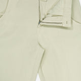A pair of Bull Denim 5-Pocket Pants by 04651/ A TRIP IN A BAG in light beige, displayed on a white background with the front zipper and button partially undone to reveal the waistband and pockets.