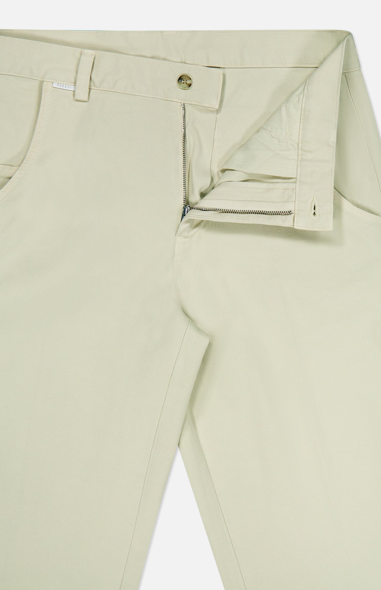 A pair of Bull Denim 5-Pocket Pants by 04651/ A TRIP IN A BAG in light beige, displayed on a white background with the front zipper and button partially undone to reveal the waistband and pockets.