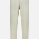 The Bull Denim 5-Pocket Pants by 04651/ A TRIP IN A BAG are beige, straight-leg cotton-blend travel pants featuring belt loops, side pockets, and a button closure, shown against a plain white background.