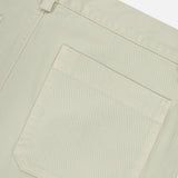 Close-up of the back pocket and waistband of the Bull Denim 5-Pocket Pants by 04651/ A TRIP IN A BAG in light beige cotton-blend fabric, highlighting the texture and stitching details against a white background.