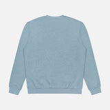 The Cotton Linen Crewneck Sweatshirt by 04651/ A TRIP IN A BAG is shown from the back in light blue, featuring long sleeves, ribbed cuffs and waistband, made from a soft organic cotton blend on a white background.