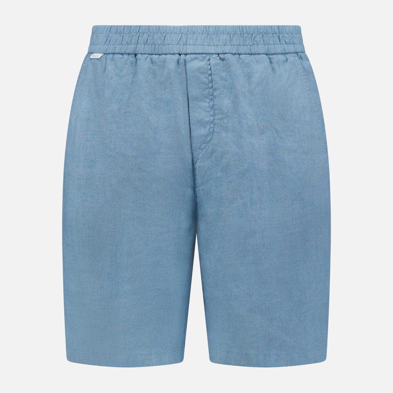The Linen Bermuda Short by 04651/ A TRIP IN A BAG features light blue linen, an elastic waistband, and a front seam. Expertly crafted in Portugal, it’s shown against a plain white background.