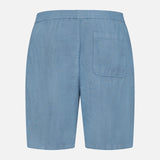 Back view of the 04651/ A TRIP IN A BAG Linen Bermuda Short in light blue, featuring an elastic waistband and a right-side patch pocket. Made in Portugal, shown against a plain white background.