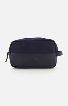 The 04651/ A TRIP IN A BAG Travel Washbag, featuring a zippered top, side handle, and embossed front logo, is shown against a white background—ideal as a compact travel toiletry bag for your essentials.