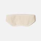 A beige fabric sleep mask with stitched edges and a gentle, contoured shape rests on a white background—perfect for slipping into your Voyage Set Tote Bag by 04651/ A TRIP IN A BAG, making it an essential companion for restful journeys.