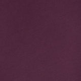 A close-up of the WJ Long Sleeve T-shirt by 04651/ A TRIP IN A BAG, shown in a plain, dark purple color with a small white clothing label visible at the neckline on the upper left side, made in Portugal.