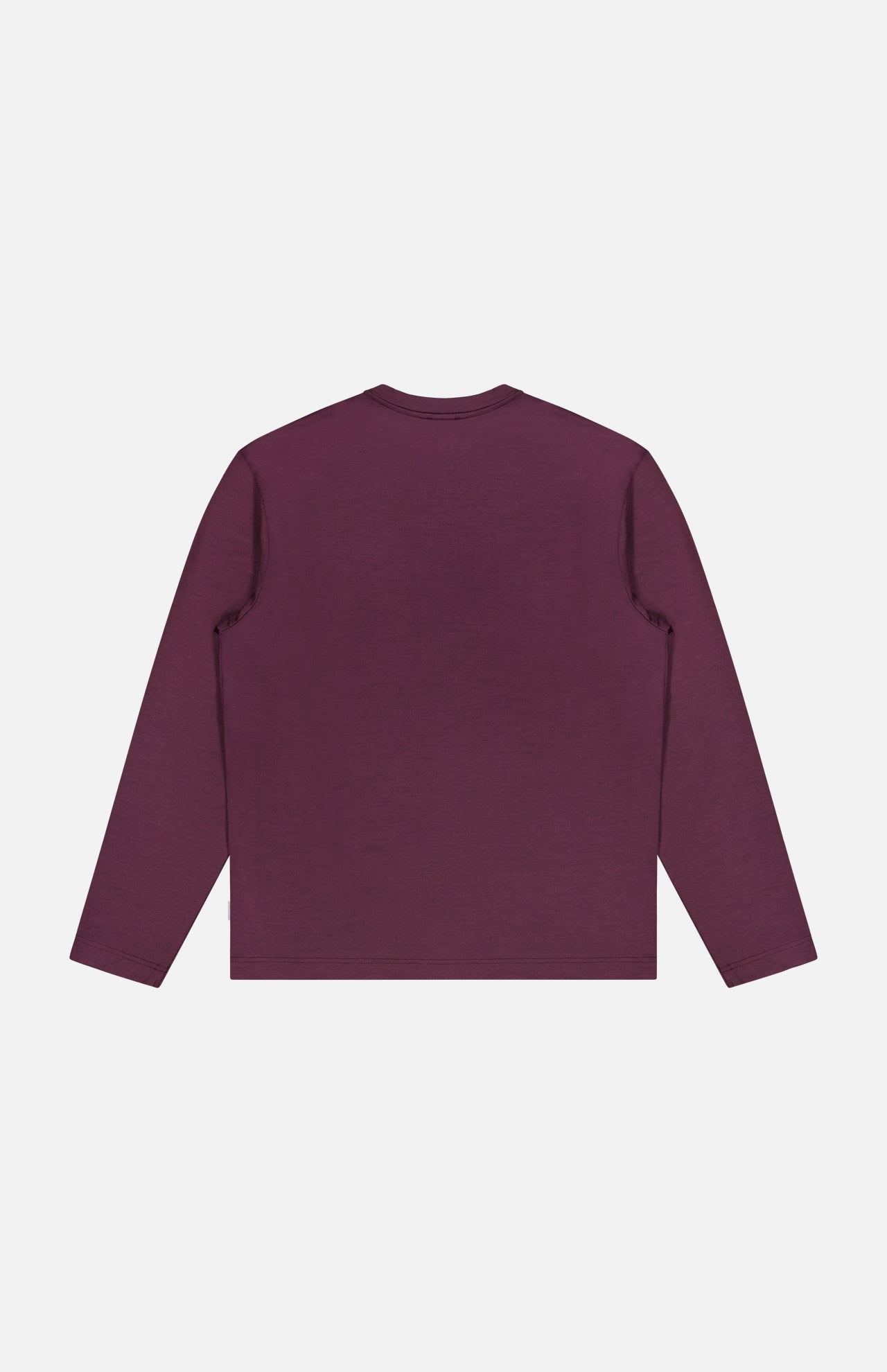 The WJ Long Sleeve T-shirt by 04651/ A TRIP IN A BAG is shown laid flat with the back side visible against a white background. This minimalist, solid dark purple tee is crafted in Portugal for premium quality and comfort.