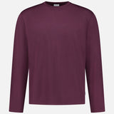 The WJ Long Sleeve T-shirt by 04651/ A TRIP IN A BAG, a plain burgundy crew neck shirt made in Portugal, is displayed on a white background.