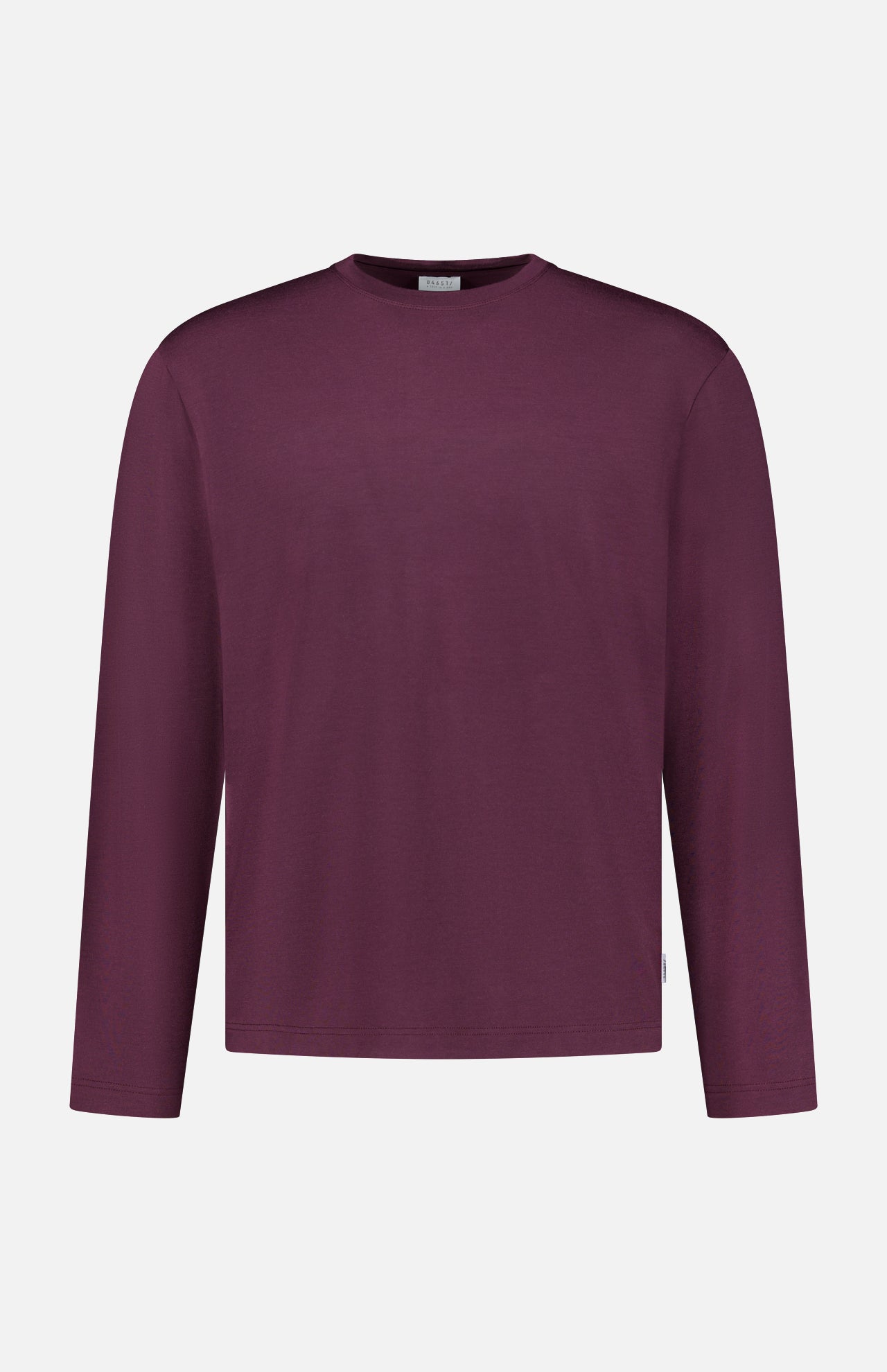 The WJ Long Sleeve T-shirt by 04651/ A TRIP IN A BAG, a plain burgundy crew neck shirt made in Portugal, is displayed on a white background.
