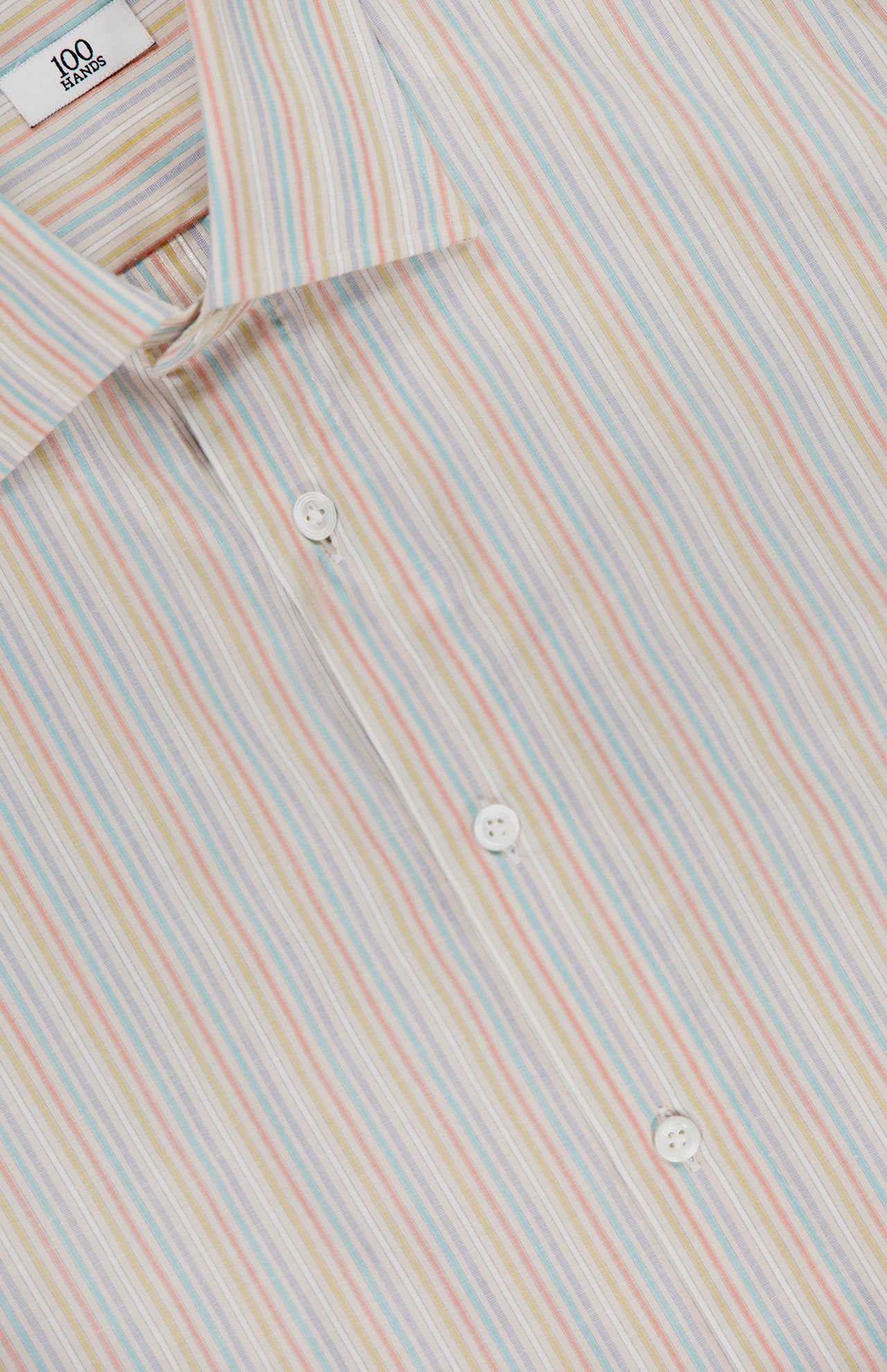 Close-up of the 100 HANDS Multi Stripe Dress Shirt, a button-down made in India with thin vertical stripes in blue, orange, yellow, and white. Features white buttons and a visible collar.