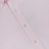 A close-up of the 100 HANDS Oxford Casual Fit Shirt, crafted in India from luxurious light pink cotton, features a pointed collar, white buttons, and is laid flat to showcase its exquisite texture and meticulous stitching.