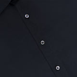 Close-up of the 100 HANDS Silk Casual Fit Dress Shirt in black, highlighting the collar, five black buttons, and a section of the front panel. The smooth, matte silk fabric exemplifies the refined craftsmanship characteristic of every shirt from 100 HANDS.