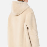 A person viewed from behind, wearing a beige Max Mara Teddy Hooded Coat.
