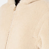 A person wears a beige Max Mara Teddy Hooded Coat made of textured material.