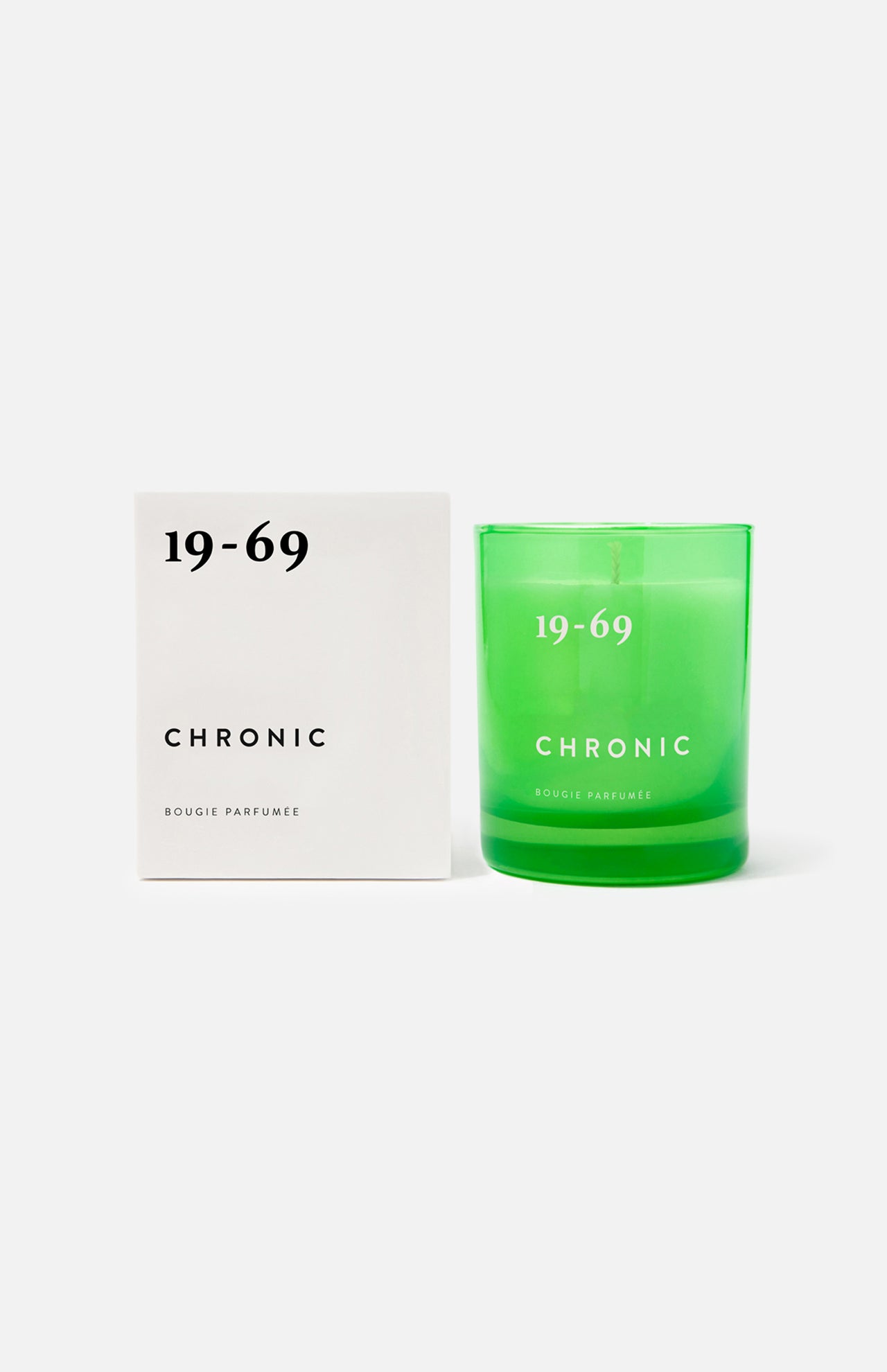 A green 19-69 Chronic Candle sits beside a matching white box on a plain background, delivering a distinctive unisex scent inspired by cannabis.