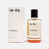 A 100 ml bottle of 19-69 Kasbah EDP Fragrance sits beside its white box, both displaying minimalist black text from the 19-69 brand on a clean white background.