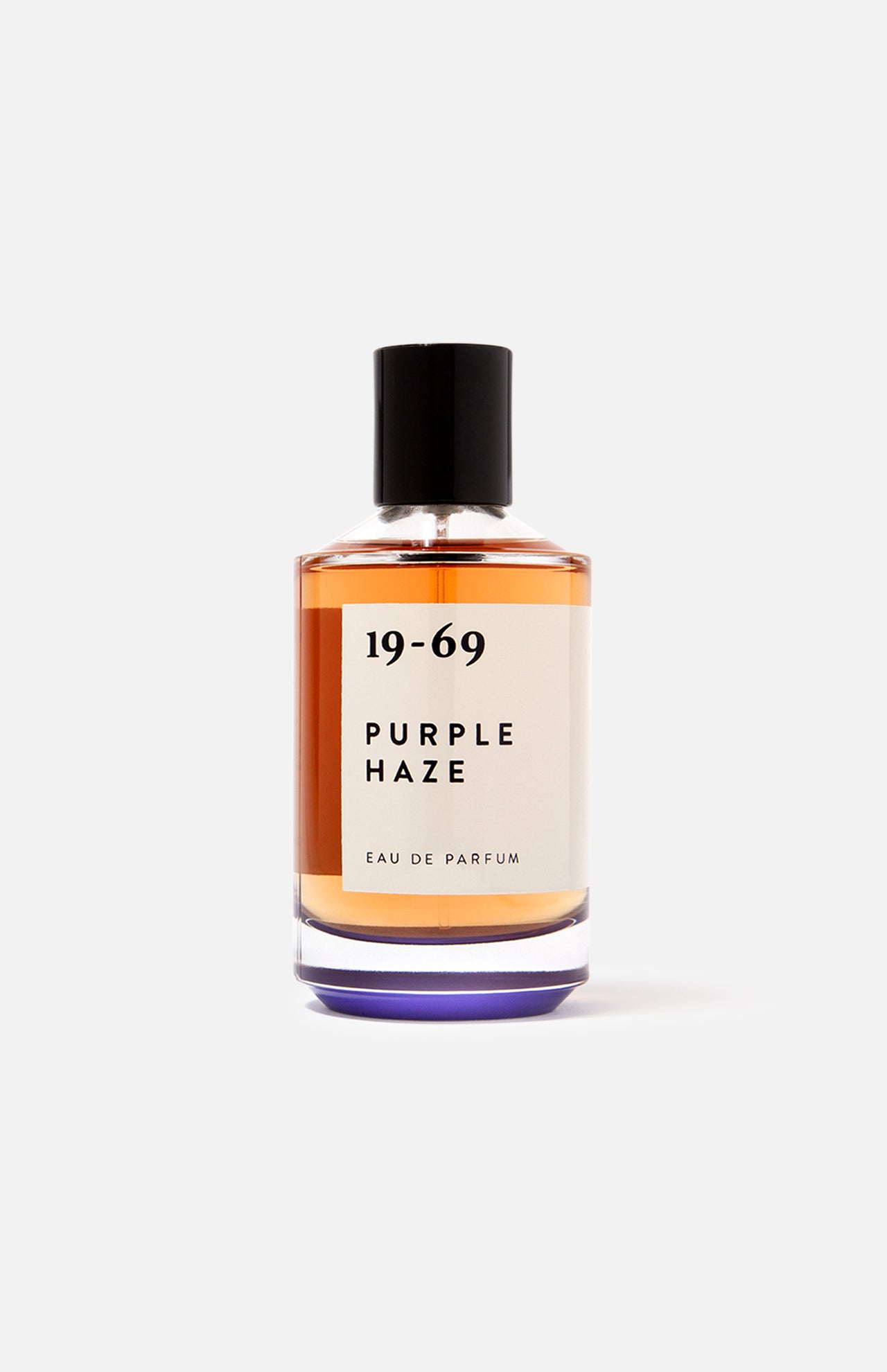 The 19-69 Purple Haze EDP 100 ml Fragrance is a Woodstock-inspired unisex scent in a clear glass bottle with amber liquid, black cap, and minimalist black-on-white label for a unique fragrance experience.