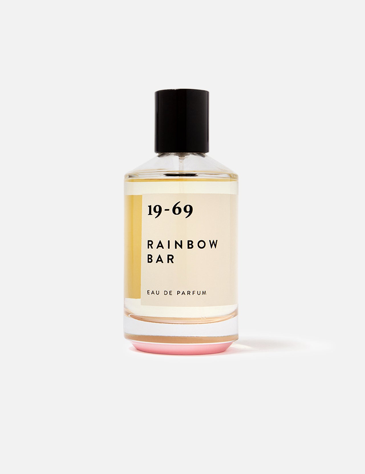 A 100 ml bottle of 19-69 Rainbow Bar EDP Fragrance, a unisex scent inspired by '80s glam rock, in clear glass with a black cap and cream label, displayed on a plain white background.