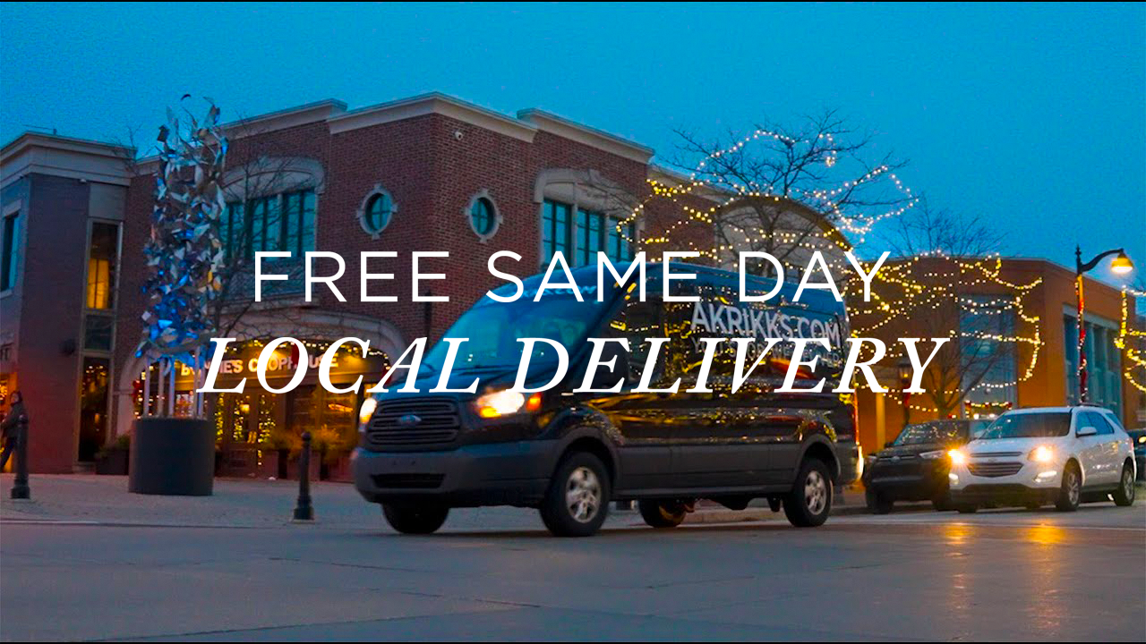 image with text "Free same day local delivery" image is of a delivery van driving through a Christmas light lit city street