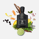 A black CREED Absolu Aventus 100 ml Fragrance bottle is surrounded by lime, flowers, leaves, peppercorns, citrus peels, and berries on a white background, highlighting the fragrance’s fresh and natural ingredients. The arrangement emphasizes the signature CREED scent with its vibrant citrus aroma and subtle notes of pineapple and patchouli.