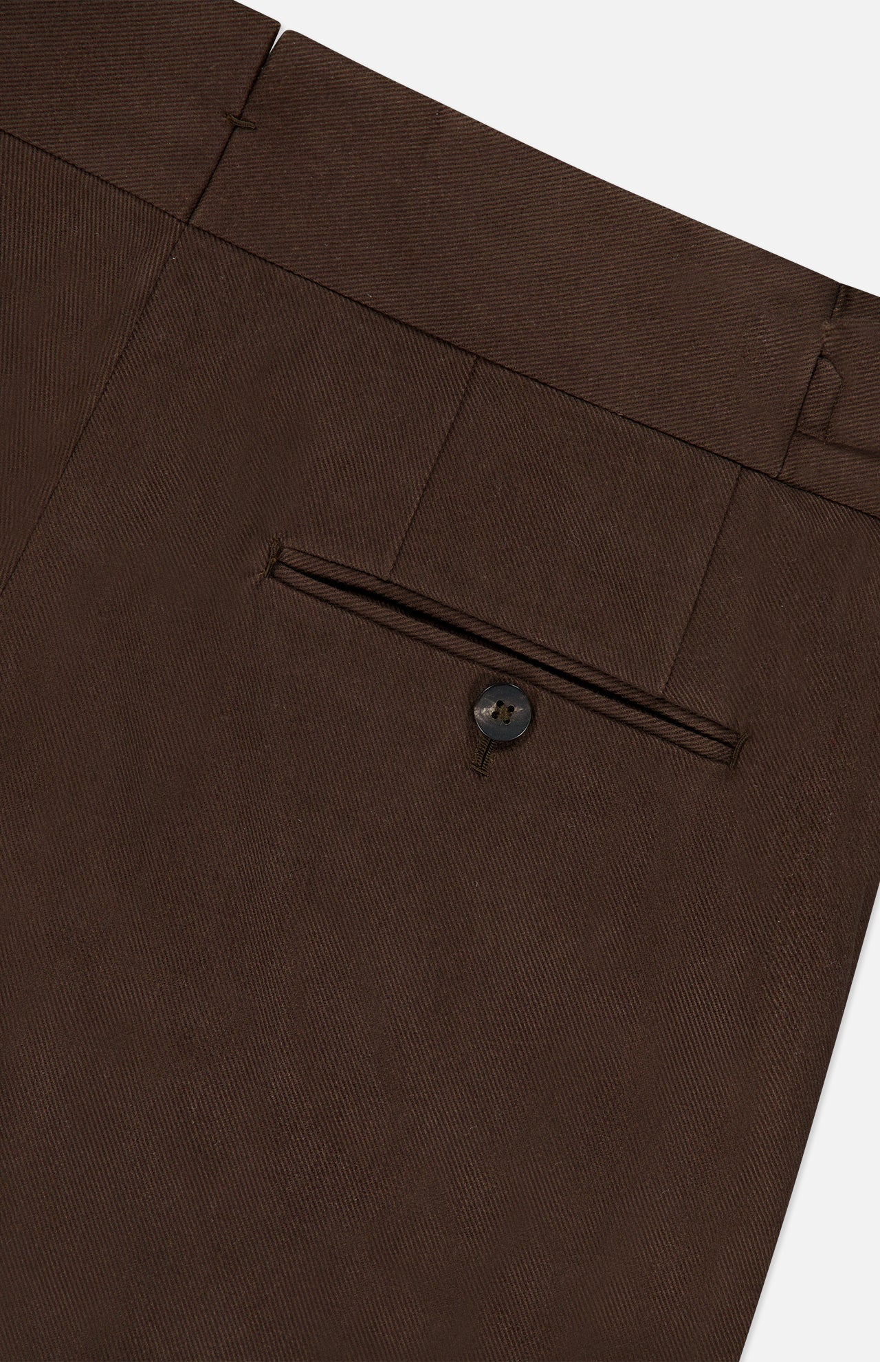 Close-up of the ISAIA Dynamic Comfort Casalnuovo Trouser Pant in dark brown, crafted in Italy, highlighting a back welt pocket with a button and part of the waistband with a belt loop.