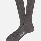 A pair of Pantherella Laburnum Short 5x3 Rib Socks in grey Merino wool, featuring white “Pantherella” text on the sole, laid flat on a white background.