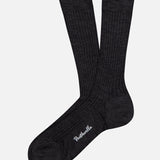 A pair of Laburnum Short 5x3 Rib Socks in dark gray Merino wool by PANTHERELLA, featuring white embroidered branding near the toe, made in England and shown on a white background.