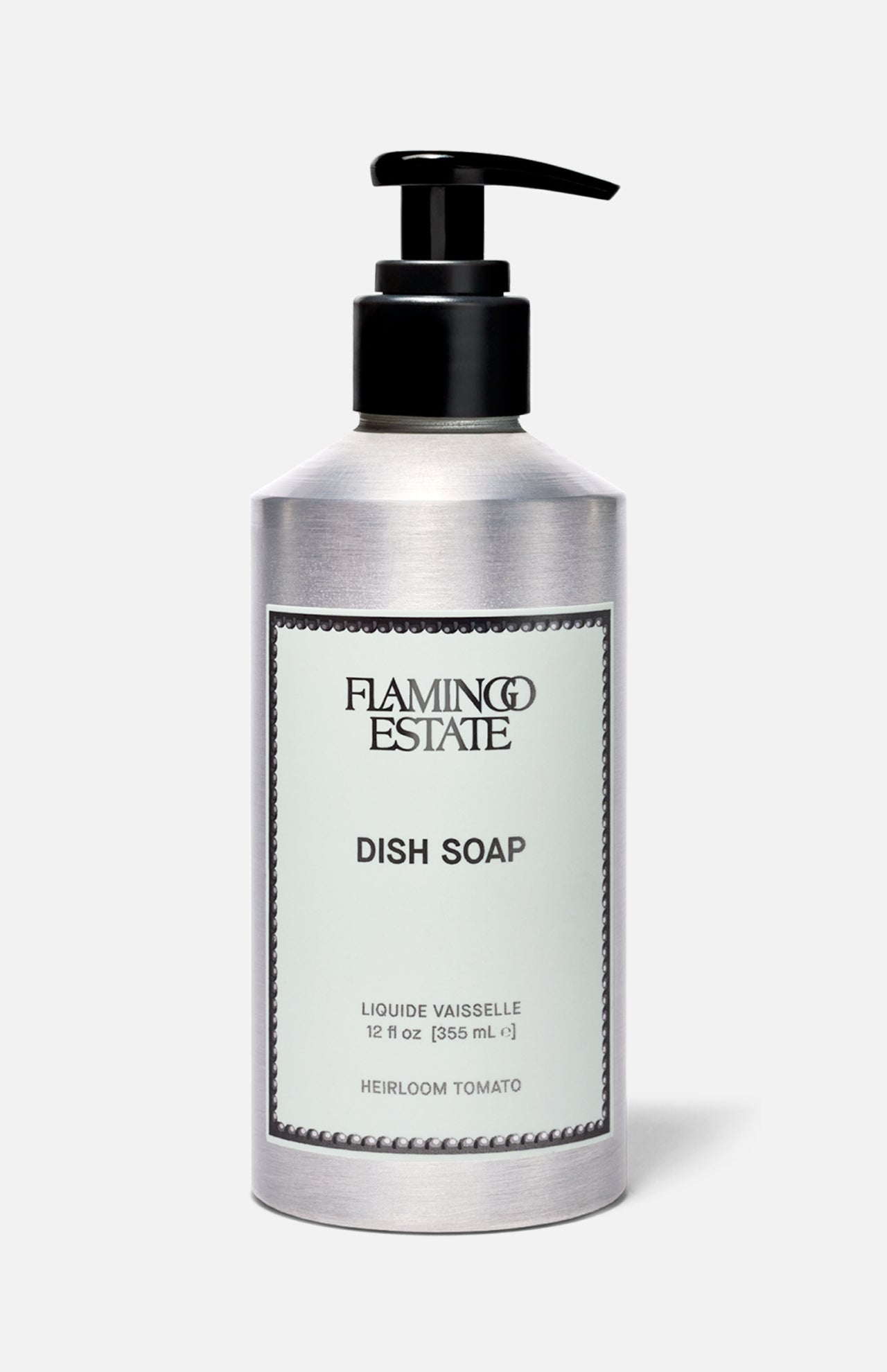 A 12 fl oz (355 ml) silver pump bottle of FLAMINGO ESTATE Heirloom Tomato Dish Soap, featuring a fresh tomato leaf scent and biodegradable cleansers, set against a plain light gray background.