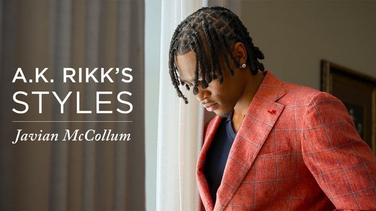 image with text "A.K. Styles Javian McCollum" image is a headshot of athlete Javian McCollum standing near a window and wearing a red sportcoat