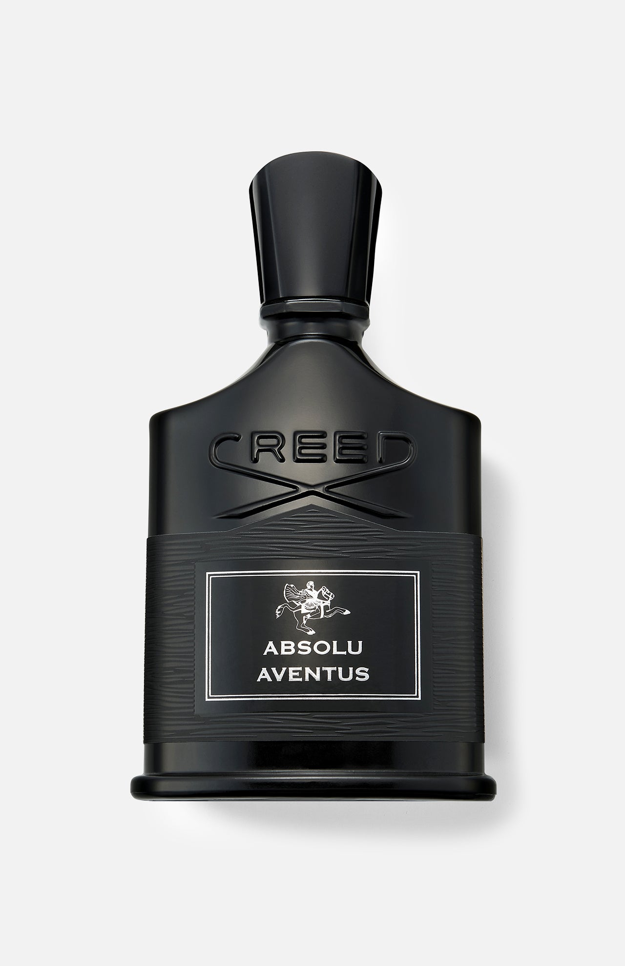A black bottle of CREED Absolu Aventus 100 ml Fragrance with a silver label, displayed against a light gray background, embodies the essence of the iconic scent with its signature citrus notes.