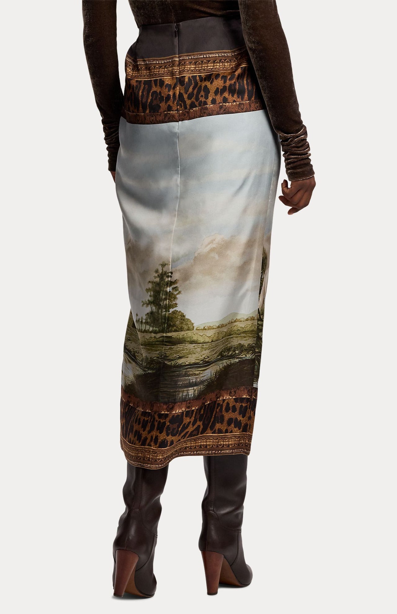 Back view of a RALPH LAUREN COLLECTION Scenic Silk Twill Pencil Skirt, a midi-length garment featuring a landscape print and leopard-print trim at the waistband and hem.