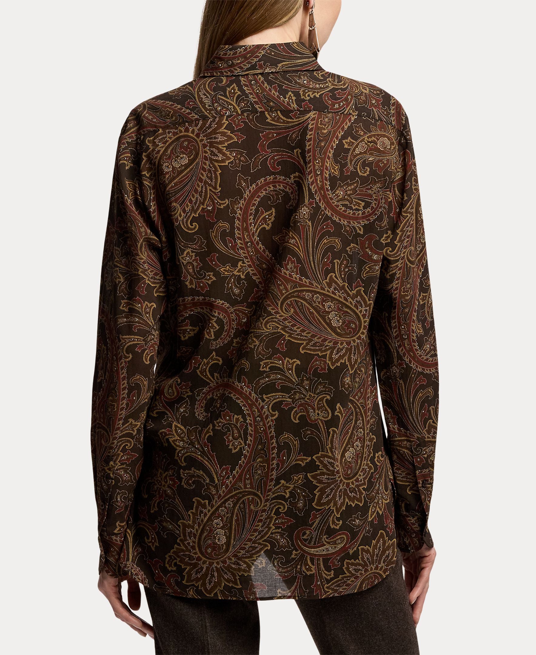 A person is seen from the back wearing the RALPH LAUREN COLLECTION Paisley Collared Long Sleeve Blouse. The blouse features a loose fit and showcases a dark brown paisley print with shades of gold and red, making it perfect for elevating any fall wardrobe. The individual stands against a plain background.