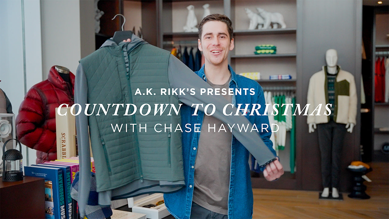 image with text "A.K. Rikk's presents Countdown to Christmas with Chase Hayward" image is of a man holding a golf outfit up on a hanger