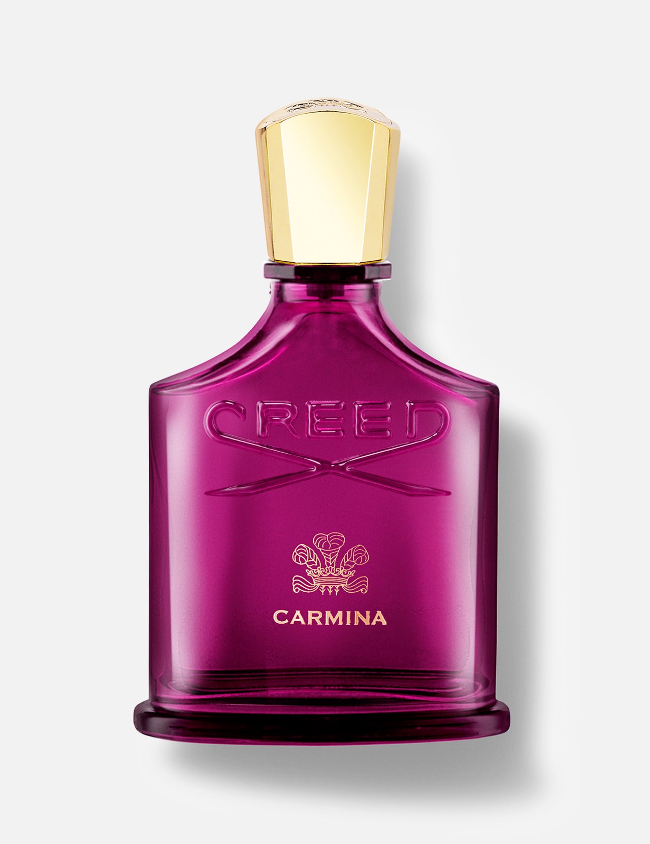 A magenta CREED Carmina perfume bottle with a gold cap and embossed logo is displayed against a white background, highlighting the luxurious Rose de Mai scent in this iconic fragrance.