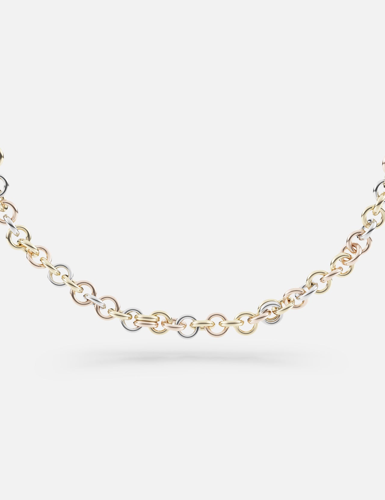 The SPINELLI KILCOLLIN Gravity Chain 20" Necklace showcases interlocking links in yellow, white, and rose gold, highlighting handmade artistry against a plain white background.