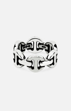 The Brute Classic Tri Link Ring by HOORSENBUHS features interlocking, rounded silver links for a bold geometric style. This unisex ring is shown against a plain white background.