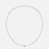 The Hello Tria Silver Necklace by SPINELLI KILCOLLIN features a minimalist sterling silver chain with a central gold cylinder accent and subtle decorative links, reflecting refined modular jewelry design.