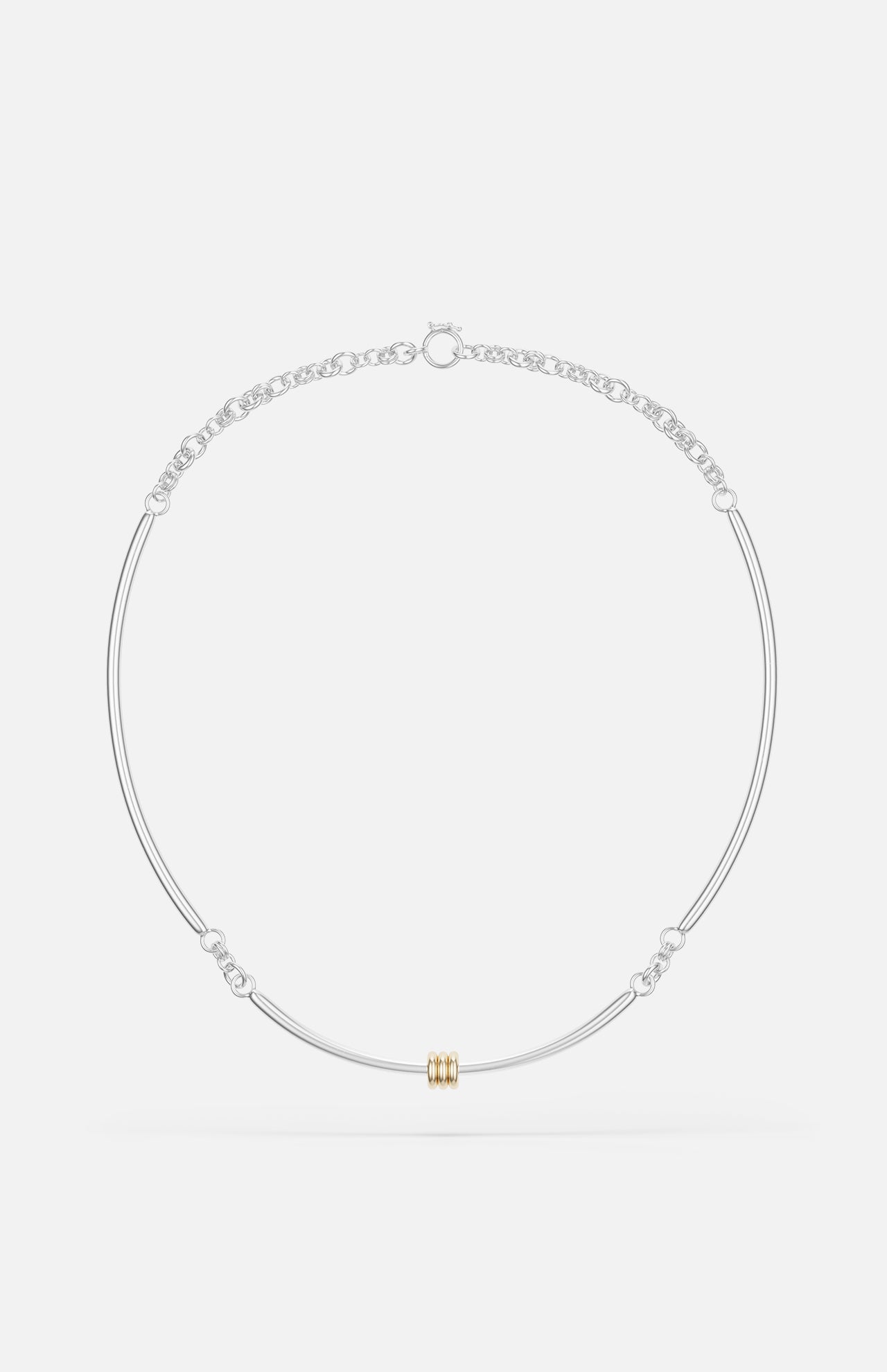 The Hello Tria Silver Necklace by SPINELLI KILCOLLIN features a minimalist sterling silver chain with a central gold cylinder accent and subtle decorative links, reflecting refined modular jewelry design.
