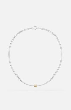 The Hello Tria Silver Necklace by SPINELLI KILCOLLIN features a minimalist sterling silver chain with a central gold cylinder accent and subtle decorative links, reflecting refined modular jewelry design.