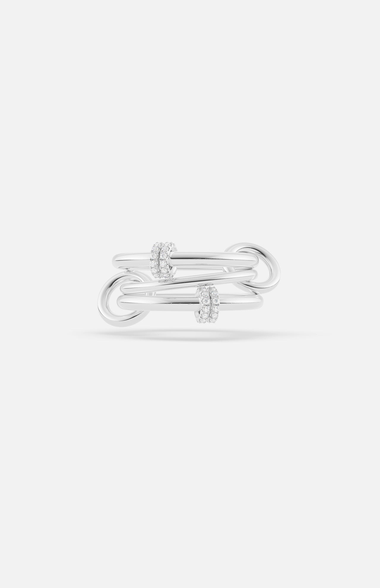 The Jovie Double Pave Ring by SPINELLI KILCOLLIN features three interlocking sterling silver bands with two groups of pavé-set clear gemstones, shown on a white background for a modern modular look.