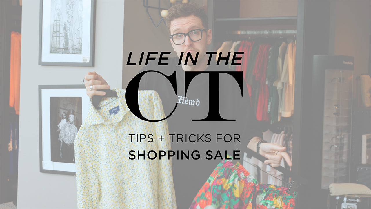image with text "life in the CT tips and tricks for shopping sale" image is of personal shopper CT McCallister holding up a printed dress thirt and a colorful pair of swim trunks
