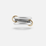 The SPINELLI KILCOLLIN Libra Gris Diamond Ring features two polished sterling silver and gold bands linked by gold loops, with a center diamond band in dark metal, shown on a plain white background.