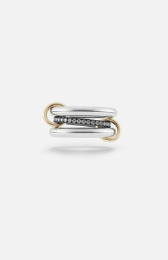 The SPINELLI KILCOLLIN Libra Gris Diamond Ring features two polished sterling silver and gold bands linked by gold loops, with a center diamond band in dark metal, shown on a plain white background.