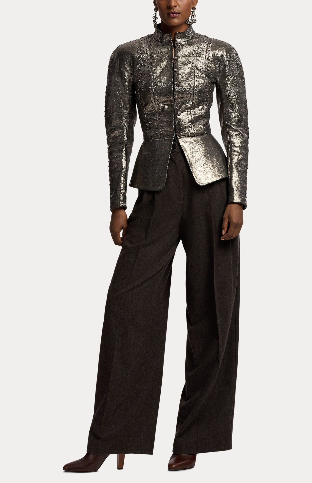 A person wearing a metallic silver long-sleeved jacket with a flared waist and RALPH LAUREN COLLECTION Mini Herringbone Standard Pants in dark brown wool flannel with a relaxed fit.