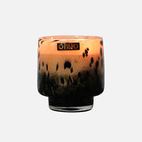 The ONNO Art Brigitte S Zanzibar Candle features a round glass holder with a black and amber leopard print, gold ONNO label, and a luxury hand-poured scented candle inside.