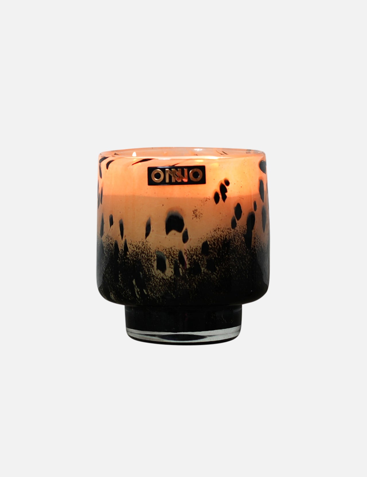 The ONNO Art Brigitte S Zanzibar Candle features a round glass holder with a black and amber leopard print, gold ONNO label, and a luxury hand-poured scented candle inside.